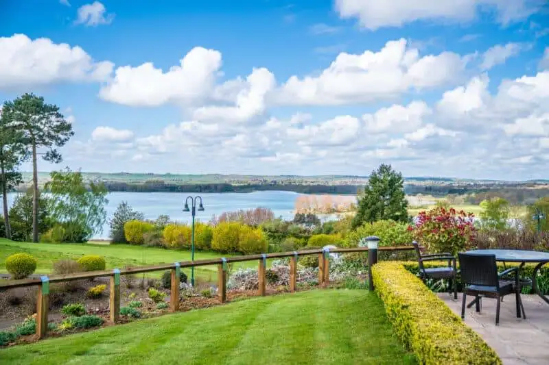 Outdoor patio and dining area on the grounds of Rutland Hall Hotel with view of Rutland Water