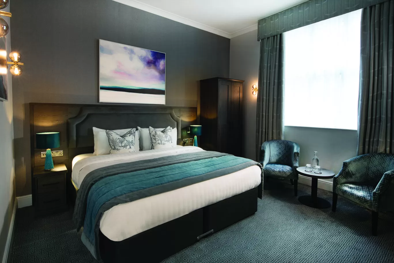 A ground floor bedroom at Rutland Hall. This is the room type, Classic Double, which is modern and spacious with high ceilings and stone windows.