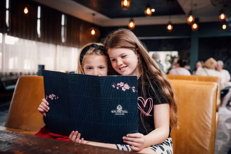 Two Children reading the menu in Blossoms Lounge at Rutland Hall